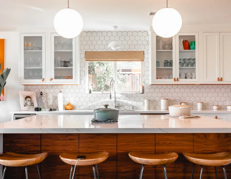 Two-tone kitchen renovation with a wood-topped island and bar seating